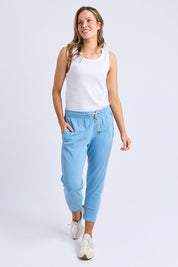 A model wearing the Fundamental Brunch Cotton Pant in colour Duskblue (Blue), from the front, showing the whole outfit