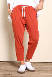 Model Pamelar wearing size 10 of the Fundamental Brunch Cotton Pant – Earthbrown in colour Earthbrown, in a cropped view