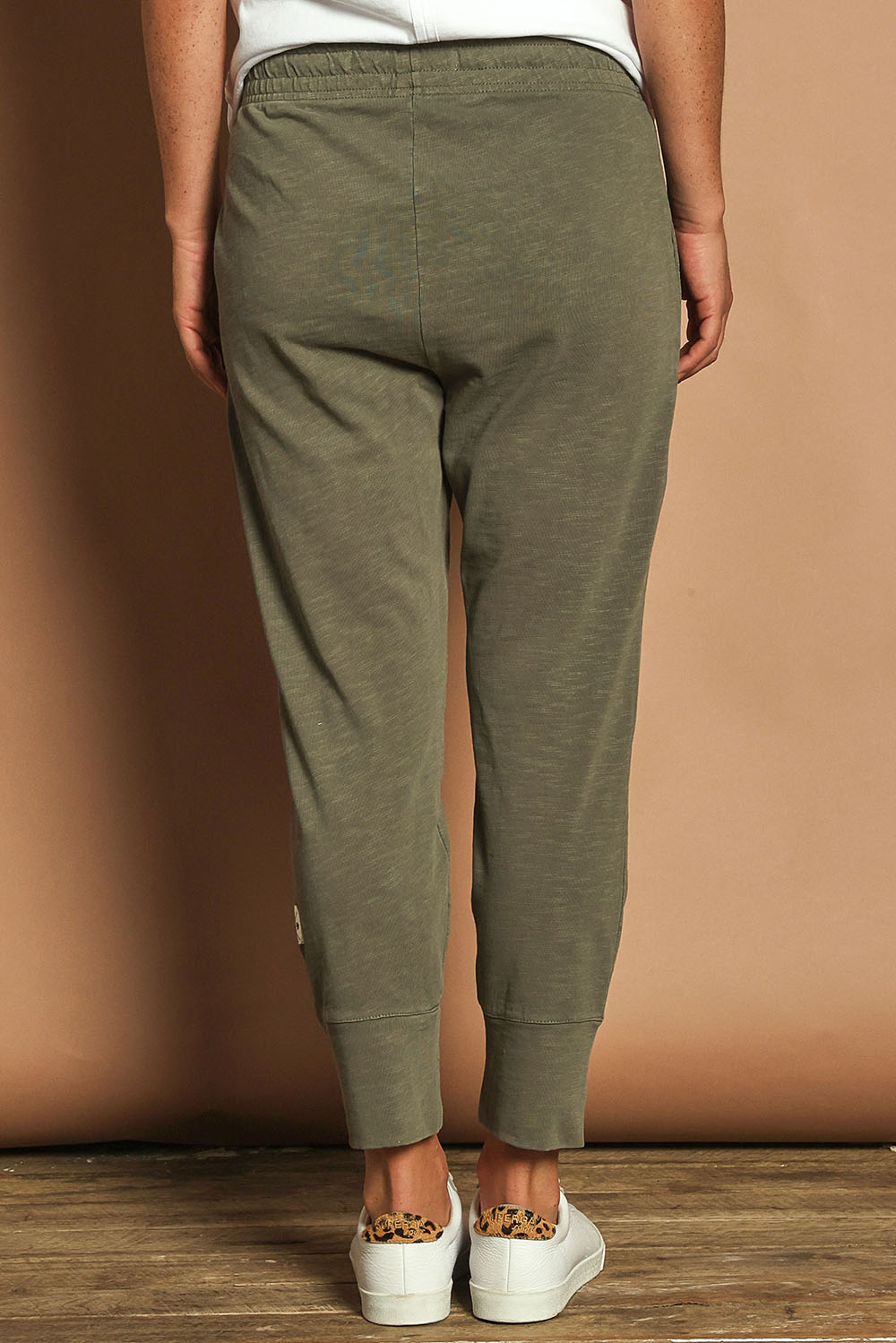 Model Katie wearing size 10 of the Fundamental Brunch Cotton Pant in colour Khaki (Green), from the back