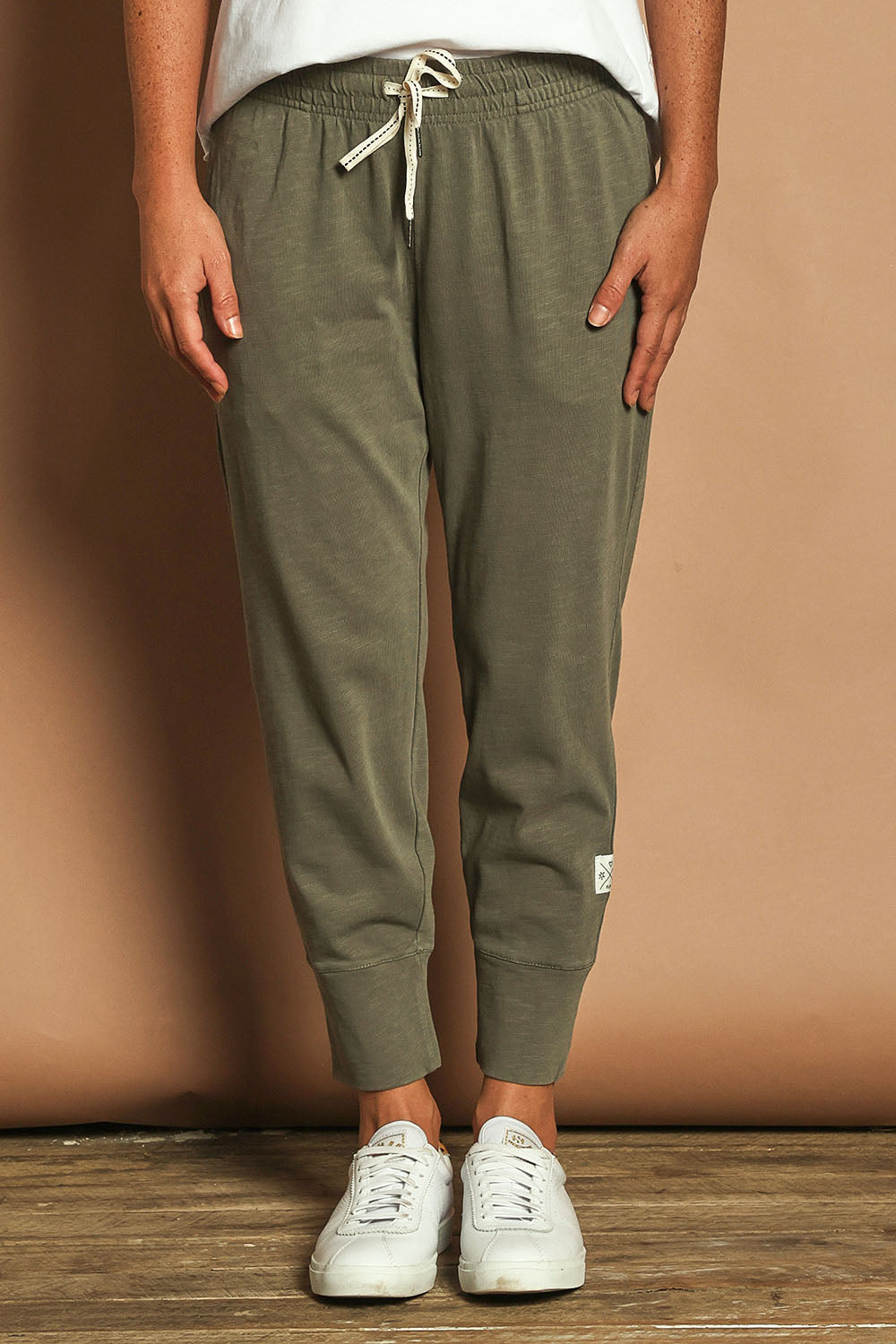 Model Katie wearing size 10 of the Fundamental Brunch Cotton Pant in colour Khaki (Green), from the front, cropped image