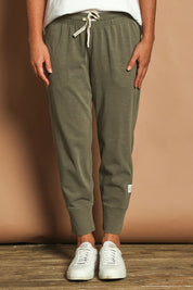 Model Katie wearing size 10 of the Fundamental Brunch Cotton Pant in colour Khaki (Green), from the front, cropped image