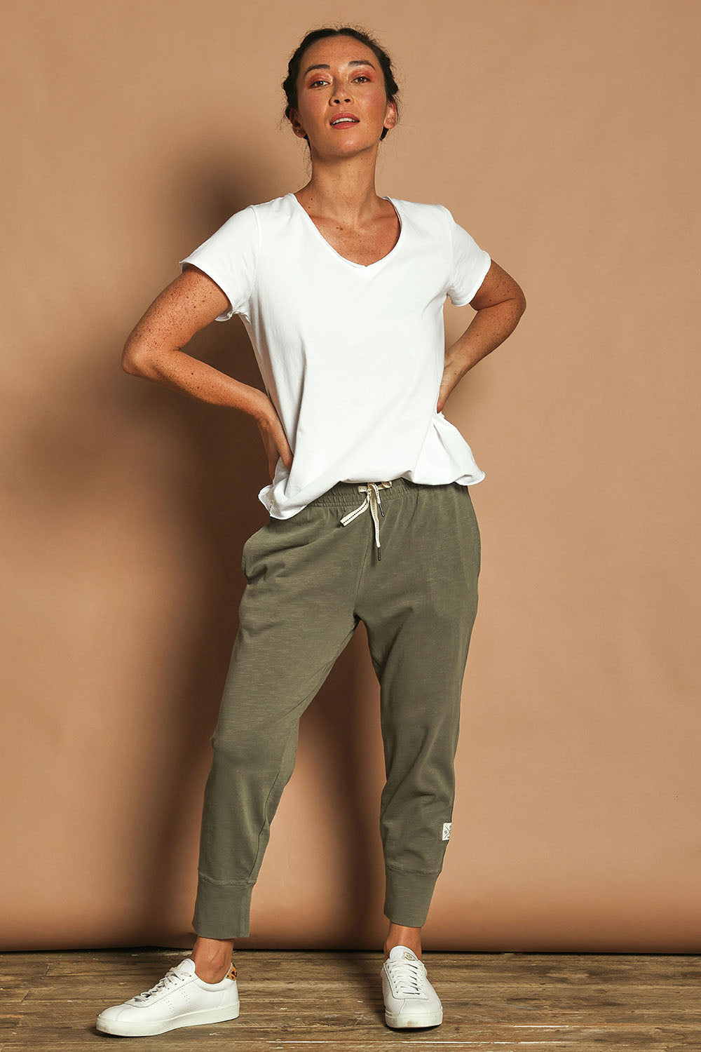 Model Katie wearing size 10 of the Fundamental Brunch Cotton Pant in colour Khaki (Green), from the front, showing the whole outfit