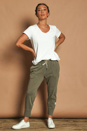 Model Katie wearing size 10 of the Fundamental Brunch Cotton Pant in colour Khaki (Green), from the front, showing the whole outfit