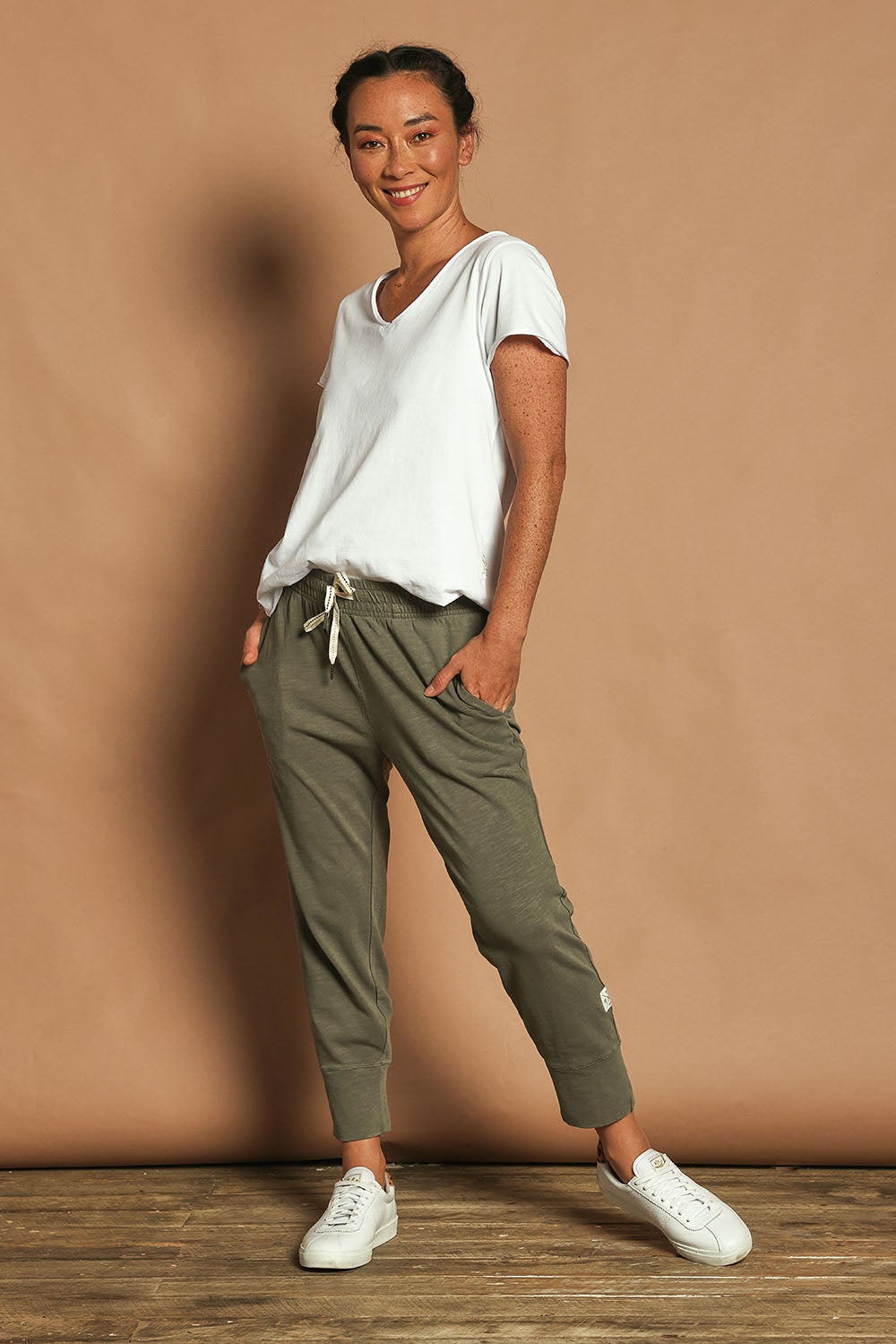 Model Katie wearing size 10 of the Fundamental Brunch Cotton Pant in colour Khaki (Green), from the front, showing the whole outfit