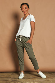 Model Katie wearing size 10 of the Fundamental Brunch Cotton Pant in colour Khaki (Green), from the front, showing the whole outfit
