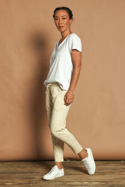 Model Katie wearing size 10 of the Fundamental Brunch Cotton Pant in colour Linen, from the front, showing the whole outfit