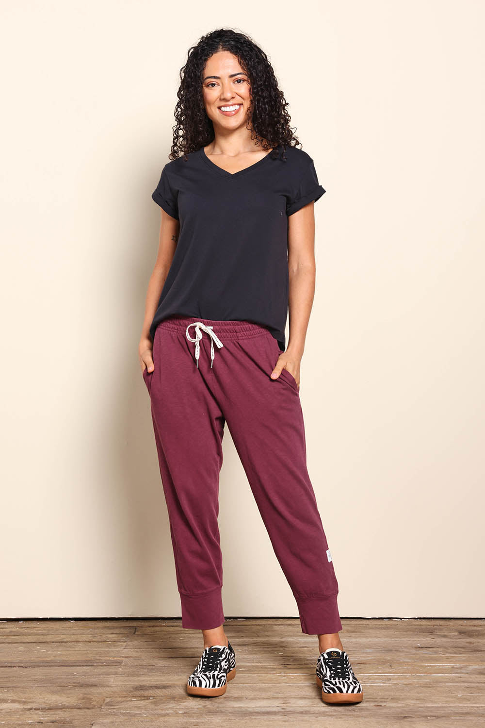 Model Pamelar wearing size 10 of the Fundamental Brunch Cotton Pant - Merlot in colour Merlot, from the front