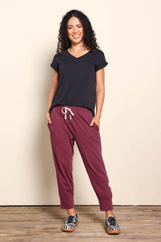 Model Pamelar wearing size 10 of the Fundamental Brunch Cotton Pant - Merlot in colour Merlot, from the front