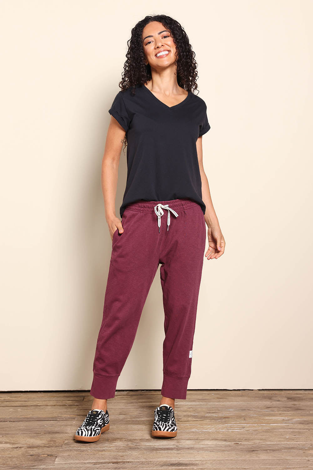 Model Pamelar wearing size 10 of the Fundamental Brunch Cotton Pant - Merlot in colour Merlot, from the front