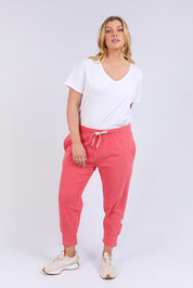 A model wearing the Fundamental Brunch Cotton Pant in colour Watermelon (Red), from the front, showing the whole outfit