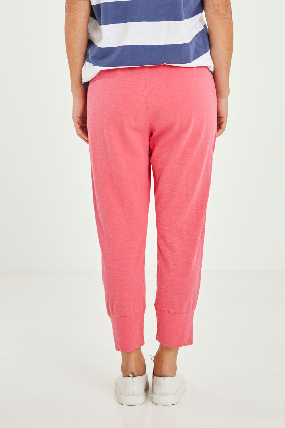 Model Katie wearing size 10 of the Fundamental Brunch Cotton Pant in colour Watermelon (Red), from the back