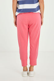 Model Katie wearing size 10 of the Fundamental Brunch Cotton Pant in colour Watermelon (Red), from the back