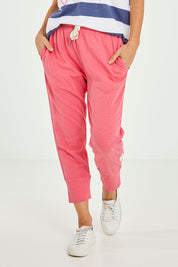 Model Katie wearing size 10 of the Fundamental Brunch Cotton Pant in colour Watermelon (Red), from the front, cropped image