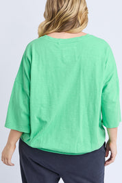 A model wearing the Fundamental Mazie Cotton Sweat Top in colour Springgree (Green), from the back