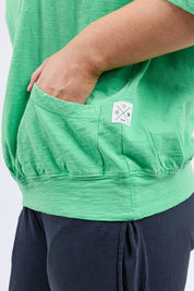 A model wearing the Fundamental Mazie Cotton Sweat Top in colour Springgree (Green), from the front, cropped image