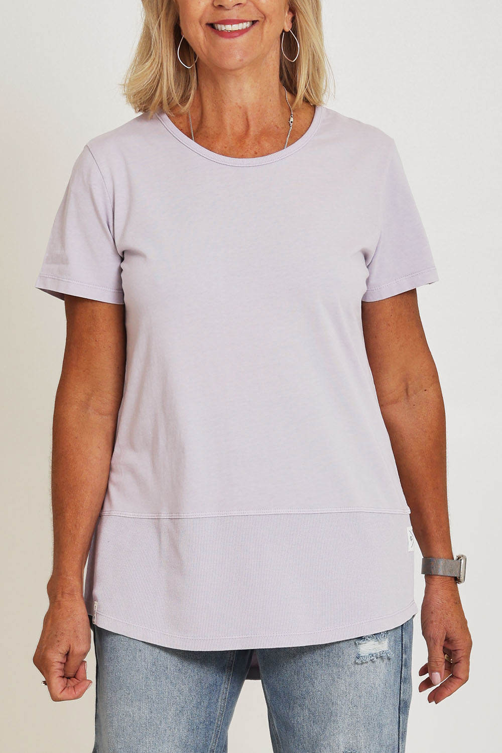 Model Sandy wearing size 10 of the Fundamental Rib Short Sleeve Cotton Tee in colour Dustylilac (Purple), from the front, cropped image