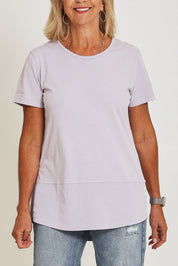 Model Sandy wearing size 10 of the Fundamental Rib Short Sleeve Cotton Tee in colour Dustylilac (Purple), from the front, cropped image