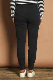 Model Katie wearing size 10 of the Fundamental Wash Out Pant in colour Navy (Blue), from the back