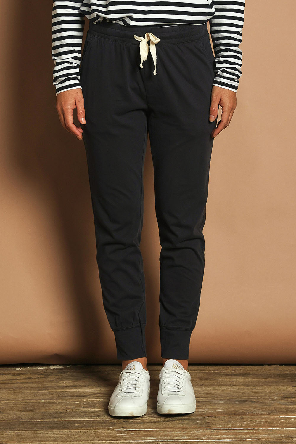Model Katie wearing size 10 of the Fundamental Wash Out Pant in colour Navy (Blue), from the front, cropped image