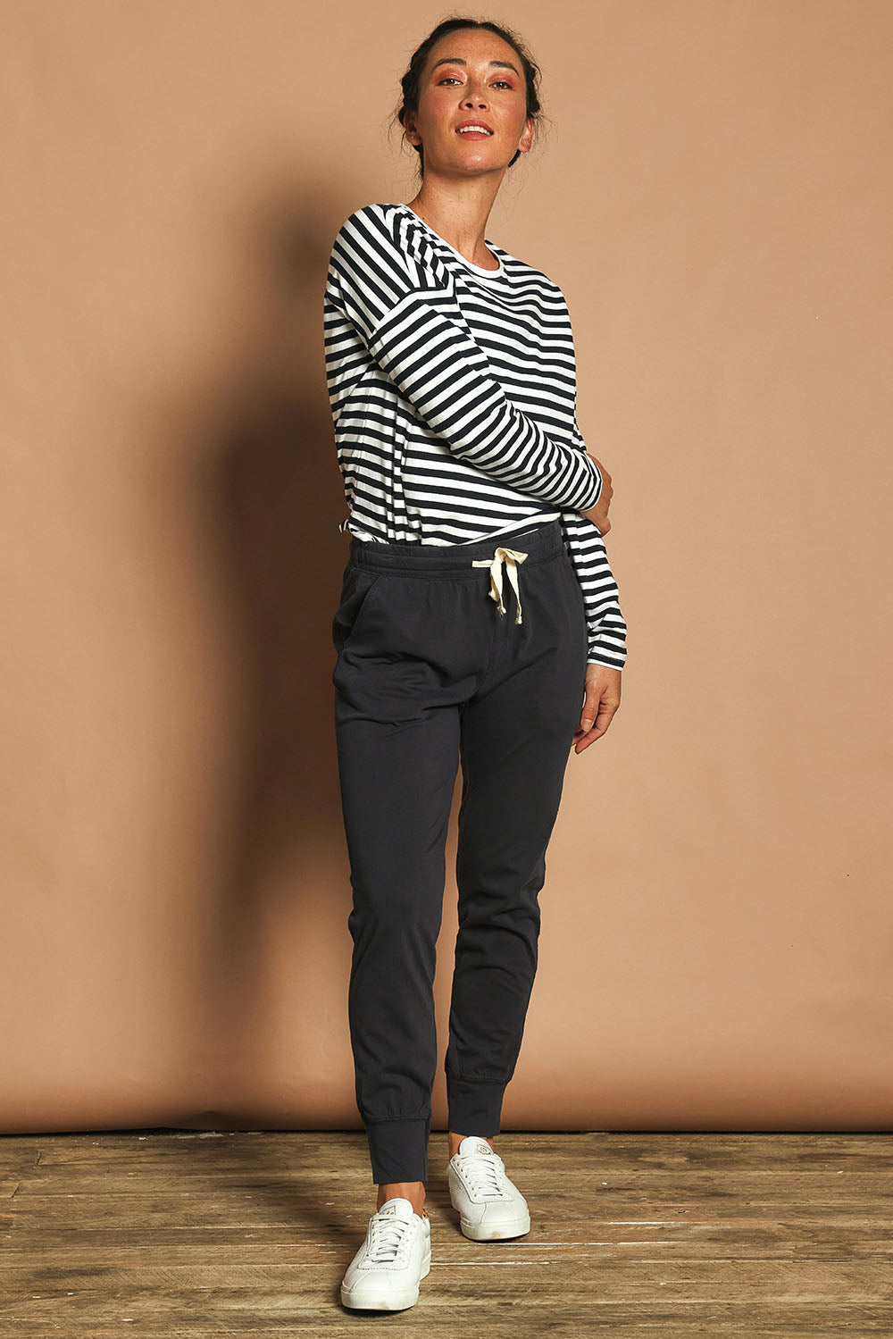 Model Katie wearing size 10 of the Fundamental Wash Out Pant in colour Navy (Blue), from the front, showing the whole outfit