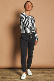 Model Katie wearing size 10 of the Fundamental Wash Out Pant in colour Navy (Blue), from the front, showing the whole outfit