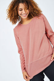 Model Summer wearing size 10 of the Fundamental Rib Long Sleeve Tee in colour DustyPink (Pink), from the front, cropped image