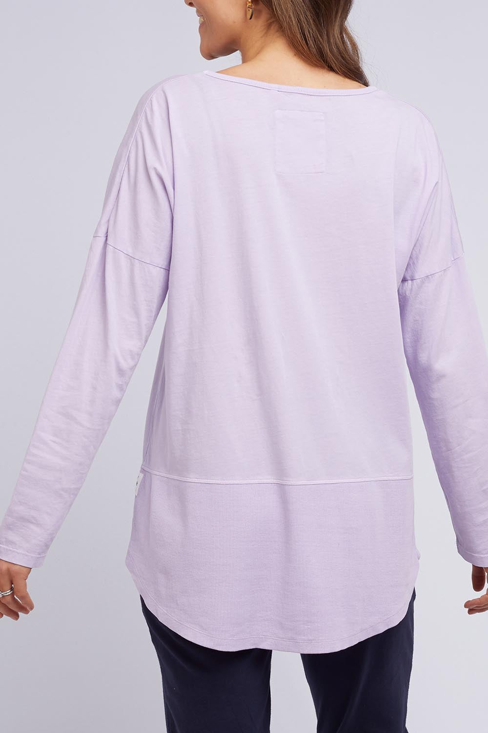 A model wearing the Fundamental Rib Long Sleeve Tee in colour Dustylilac (Purple), from the back