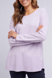 A model wearing the Fundamental Rib Long Sleeve Tee in colour Dustylilac (Purple), from the front, cropped image