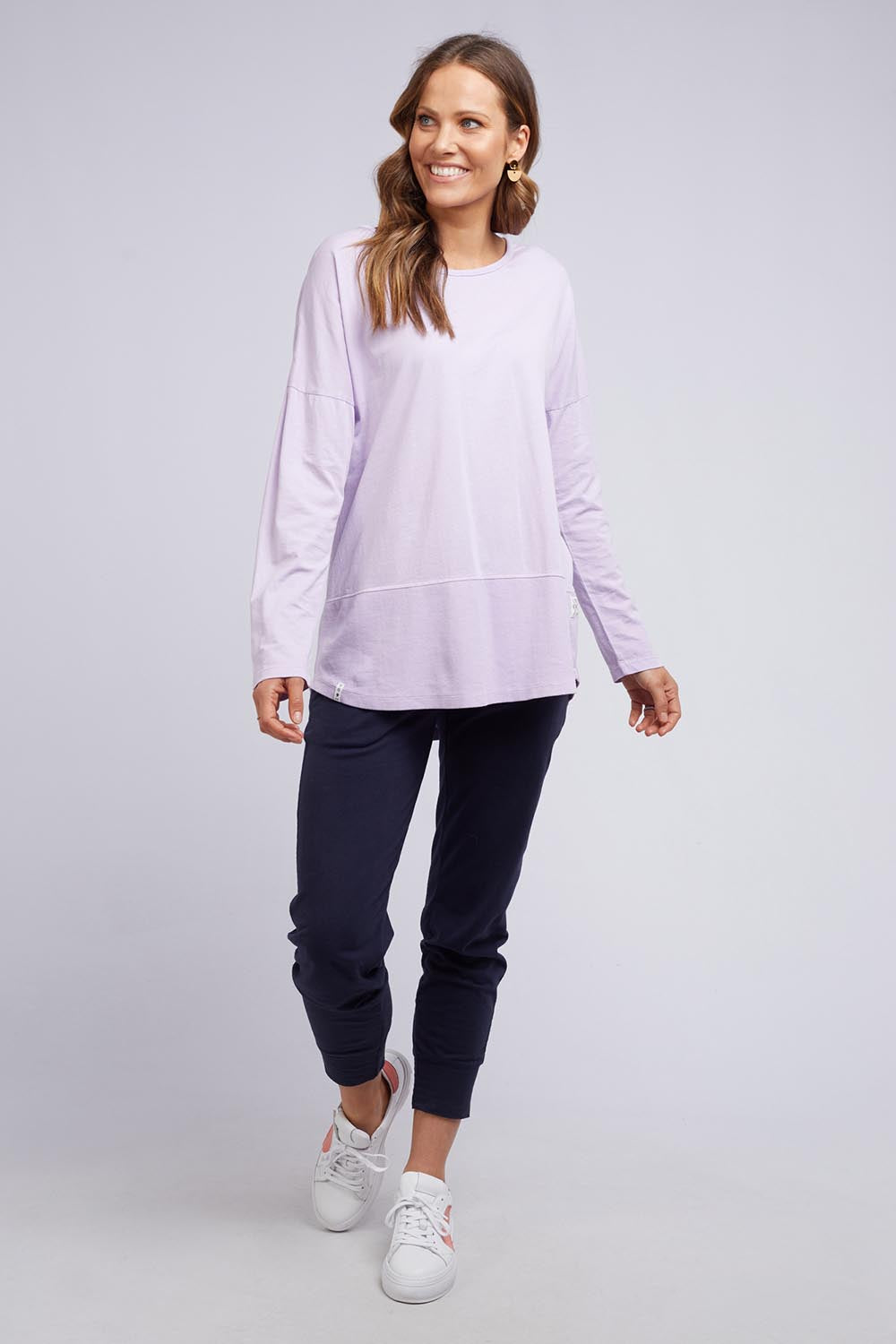 A model wearing the Fundamental Rib Long Sleeve Tee in colour Dustylilac (Purple), from the front, showing the whole outfit