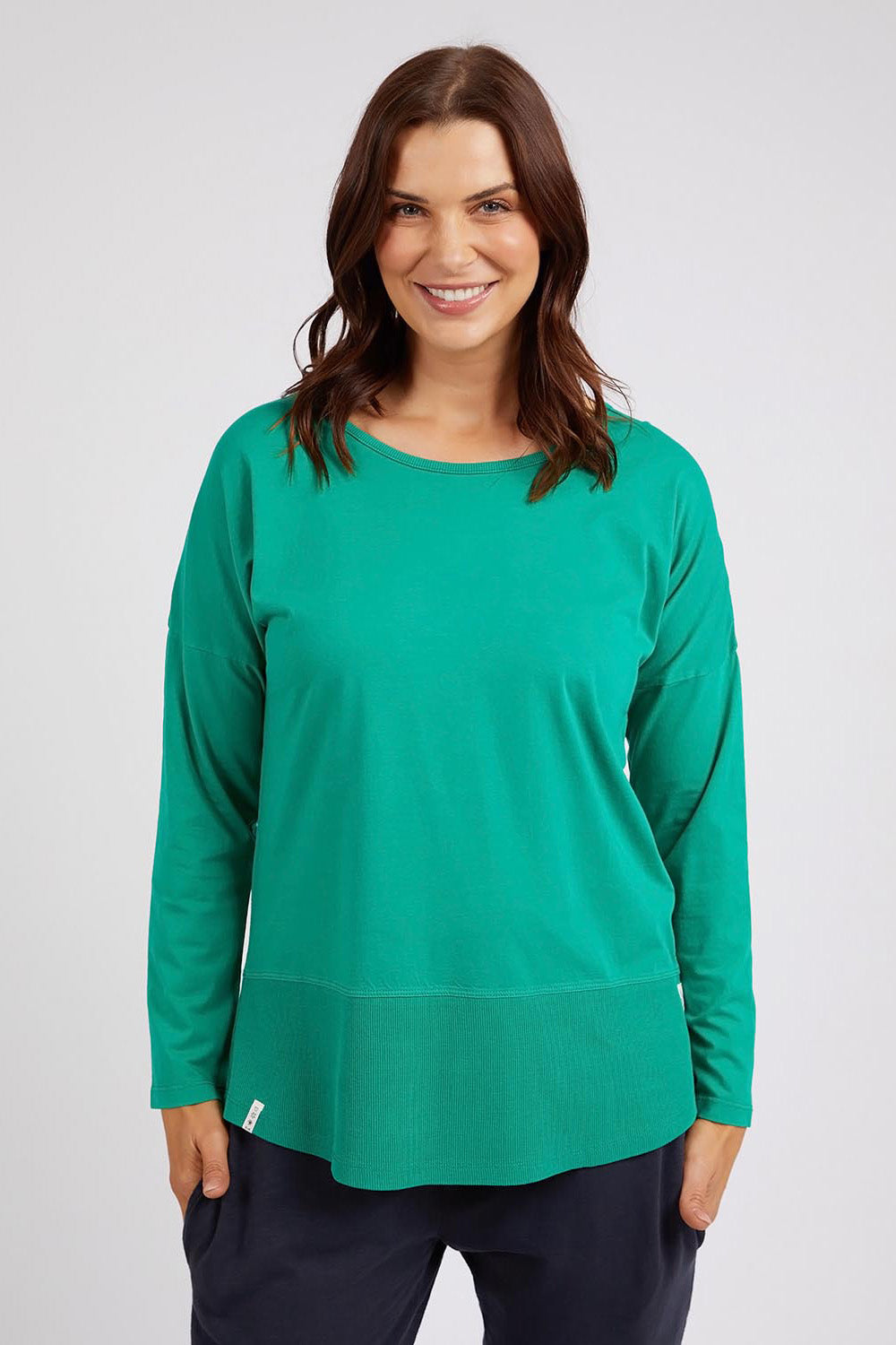 A model wearing the Fundamental Rib Long Sleeve Tee in colour Goodgreen (Green), from the front, cropped image