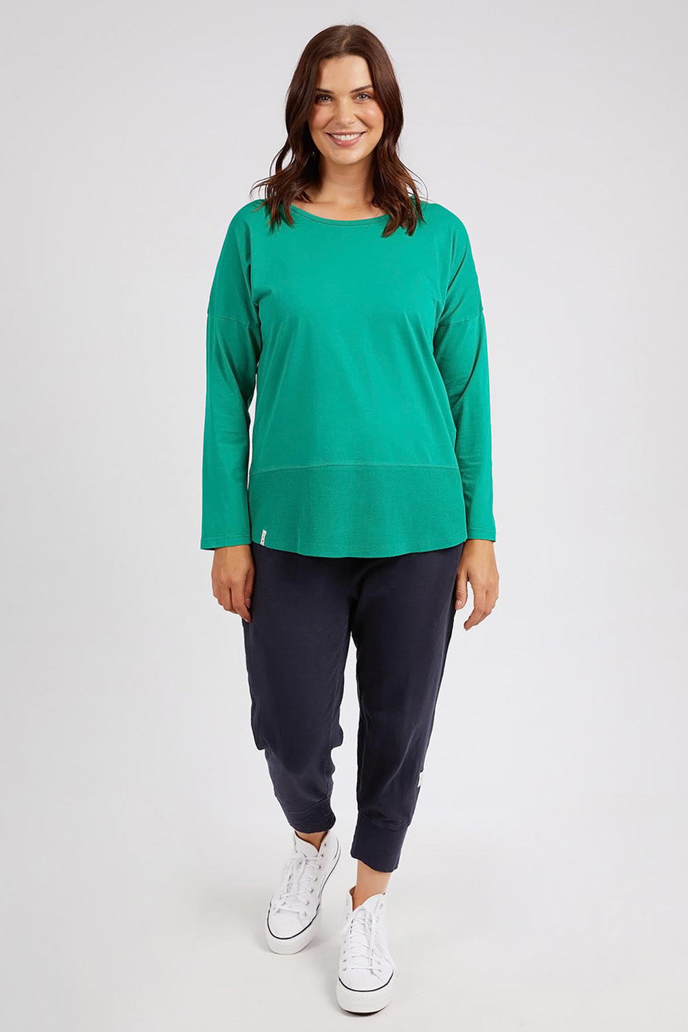 A model wearing the Fundamental Rib Long Sleeve Tee in colour Goodgreen (Green), from the front, showing the whole outfit