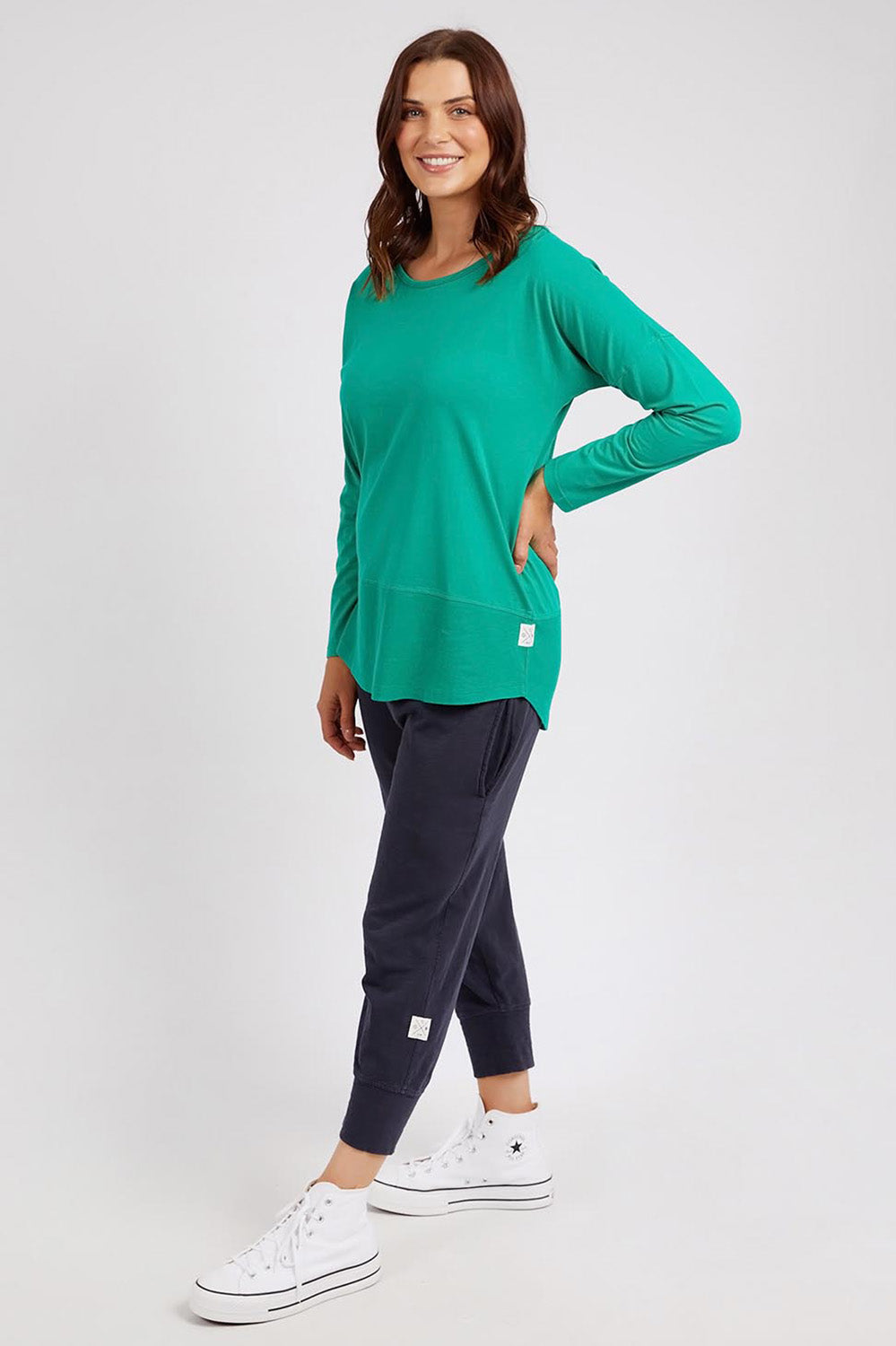 A model wearing the Fundamental Rib Long Sleeve Tee in colour Goodgreen (Green), from the front, showing the whole outfit