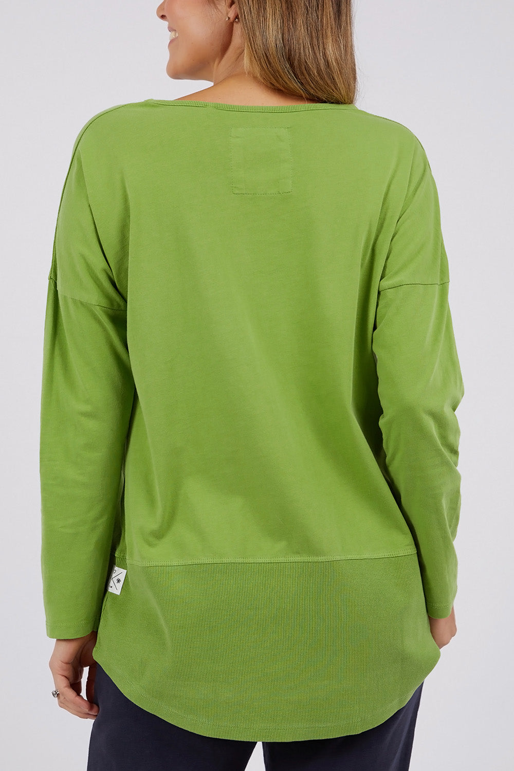 A model wearing the Fundamental Rib Long Sleeve Tee in colour Junglegre (Green), from the back