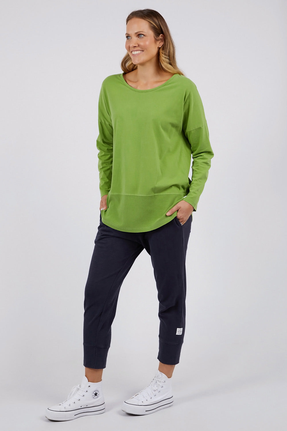 A model wearing the Fundamental Rib Long Sleeve Tee in colour Junglegre (Green), from the front, showing the whole outfit