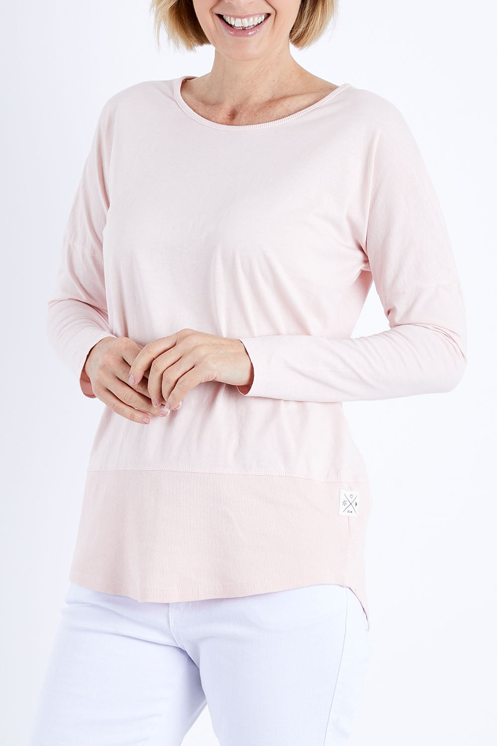 Model Veronica wearing size 10 of the Fundamental Rib Long Sleeve Tee in colour Palepink (Pink), from the front, cropped image