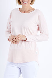 Model Veronica wearing size 10 of the Fundamental Rib Long Sleeve Tee in colour Palepink (Pink), from the front, cropped image