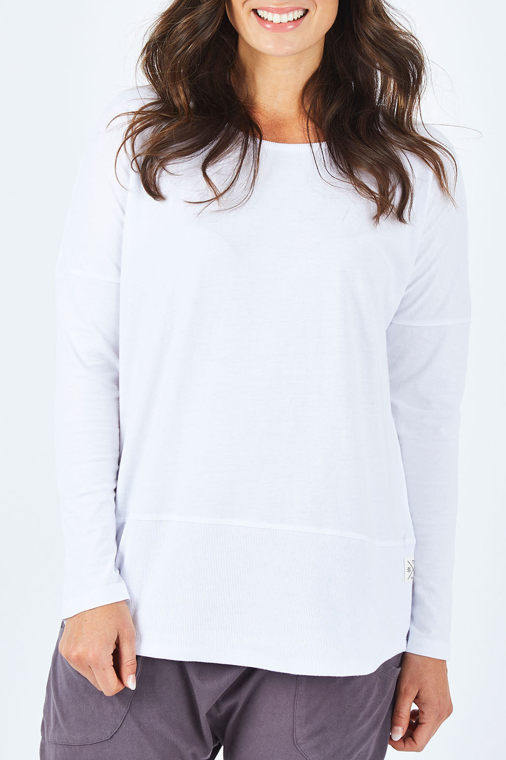 Model Shadae wearing size 10 of the Fundamental Rib Long Sleeve Tee in colour White (White), from the front, cropped image