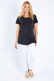 Model Bianca wearing size 10 of the Fundamental Crew Tail Tee in colour Black (Black), from the front, showing the whole outfit