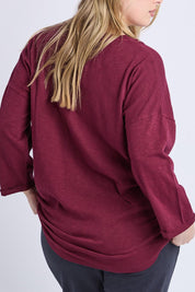 A model wearing the Fundamental Annie 3/4 Sleeve Tee in colour Plum (Purple), from the back