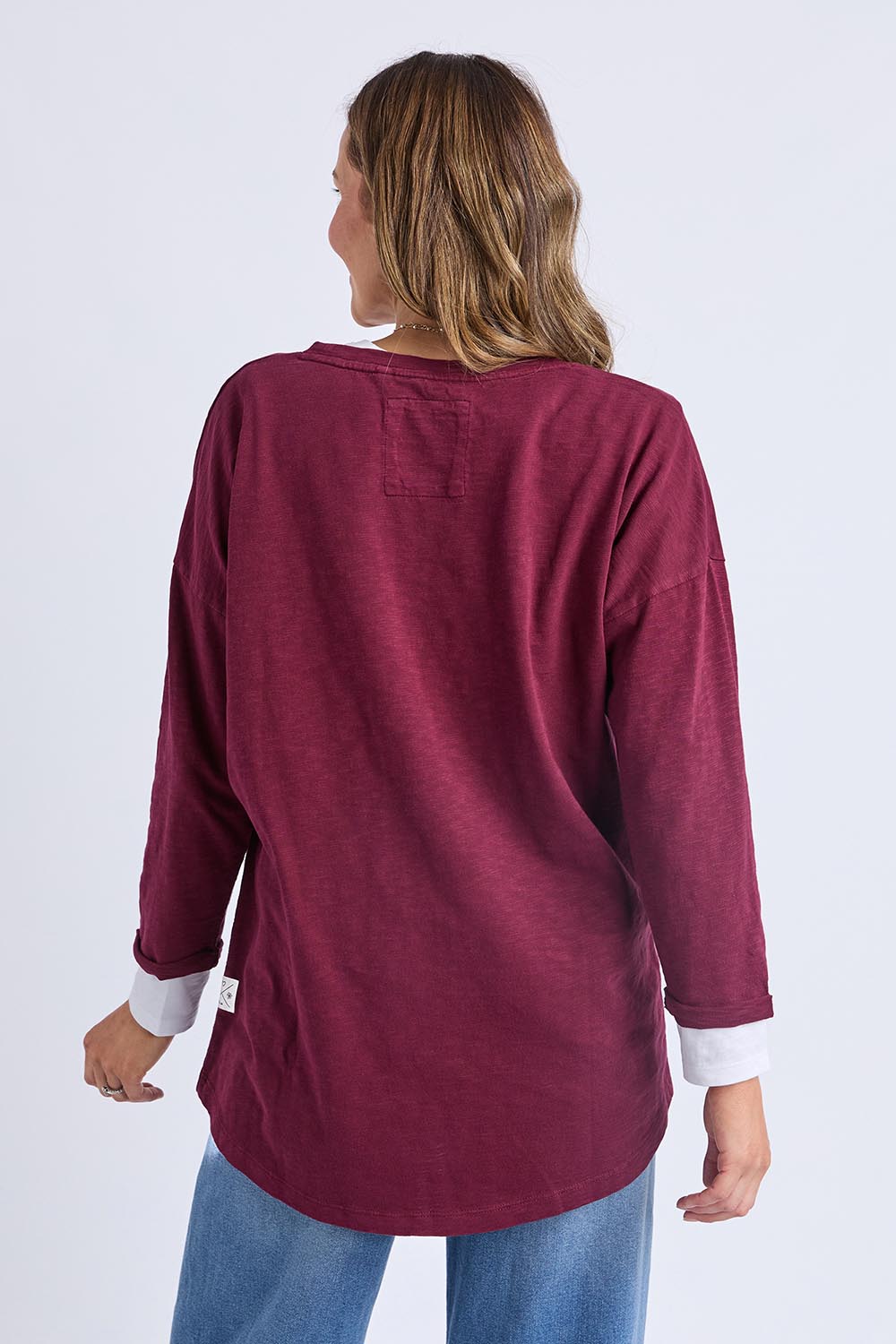 A model wearing the Fundamental Annie 3/4 Sleeve Tee in colour Plum (Purple), from the back