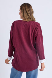 A model wearing the Fundamental Annie 3/4 Sleeve Tee in colour Plum (Purple), from the back