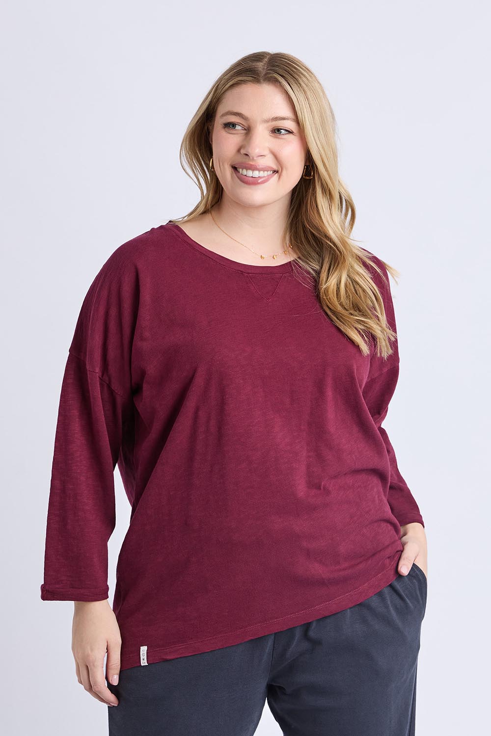 A model wearing the Fundamental Annie 3/4 Sleeve Tee in colour Plum (Purple), from the front, cropped image