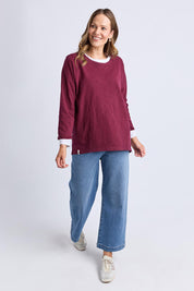 A model wearing the Fundamental Annie 3/4 Sleeve Tee in colour Plum (Purple), from the front, showing the whole outfit