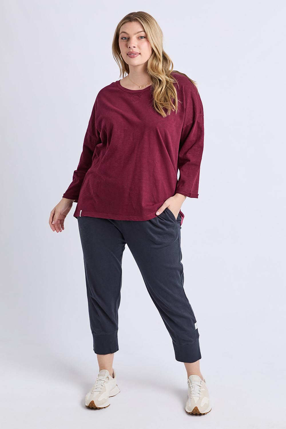 A model wearing the Fundamental Annie 3/4 Sleeve Tee in colour Plum (Purple), from the front, showing the whole outfit