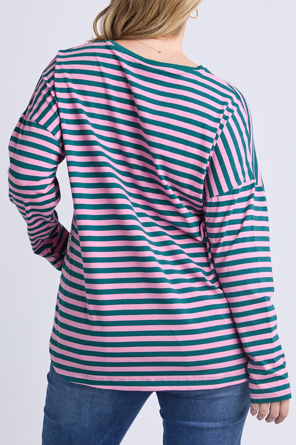 A model wearing the Fundamental Lauren Stripe LS Tee in colour Tealpink (Blue), from the back