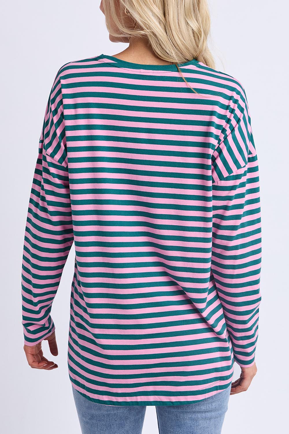 A model wearing the Fundamental Lauren Stripe LS Tee in colour Tealpink (Blue), from the back