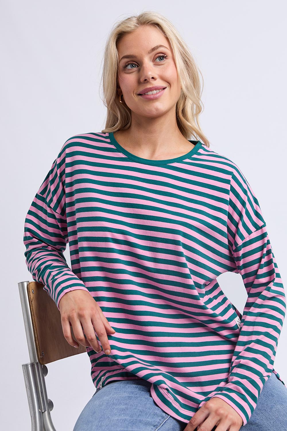 A model wearing the Fundamental Lauren Stripe LS Tee in colour Tealpink (Blue), from the front, cropped image