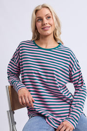 A model wearing the Fundamental Lauren Stripe LS Tee in colour Tealpink (Blue), from the front, cropped image
