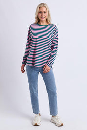 A model wearing the Fundamental Lauren Stripe LS Tee in colour Tealpink (Blue), from the front, showing the whole outfit