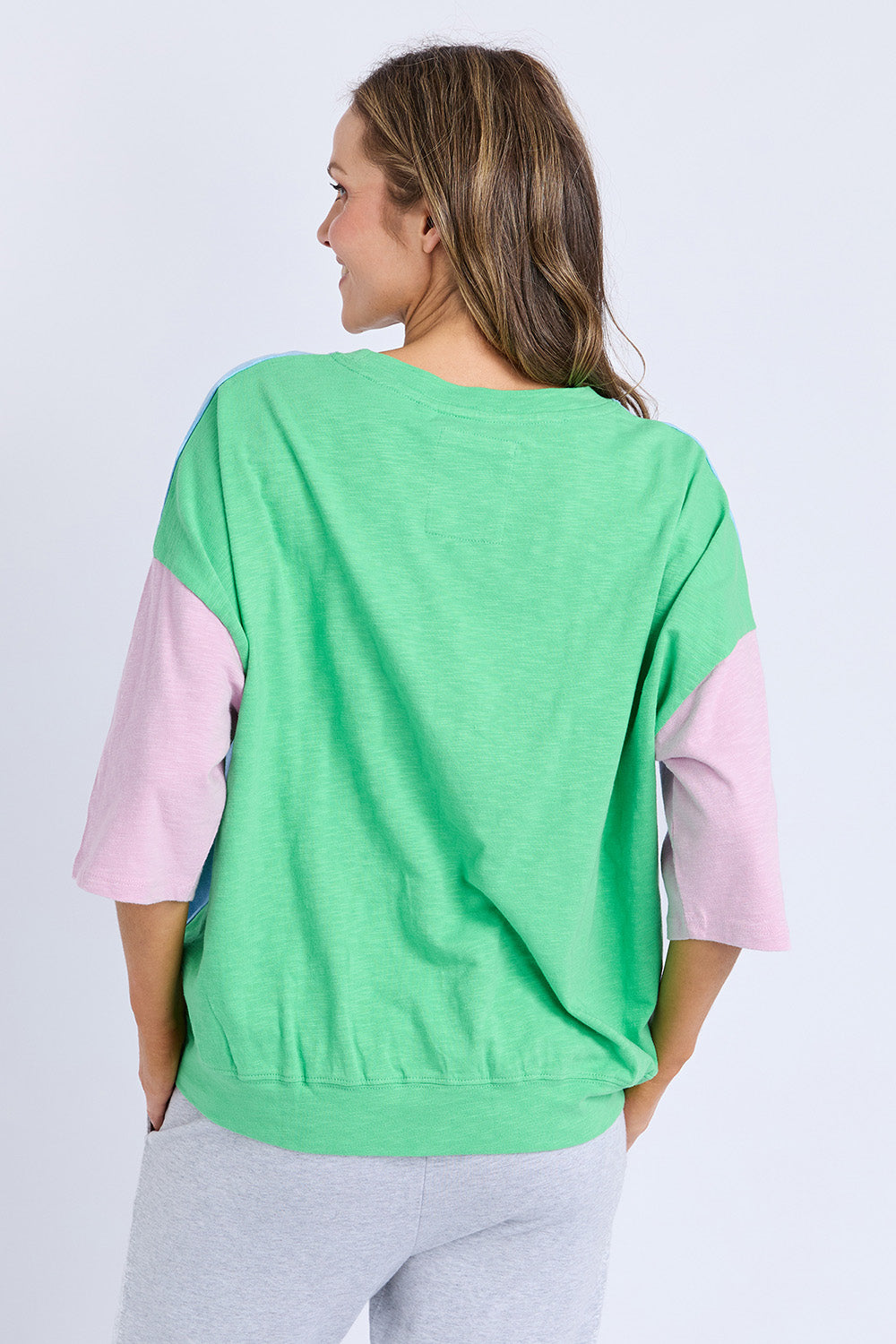 A model wearing the Fundamental Mazie Colour Block Cotton Sweat in colour Blupnkgree (Blue), from the back